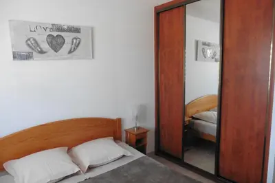 a bedroom with a mirror and a bed and a bed sidx sidx sidx at Escapade Audoise in Sallèles-dʼAude