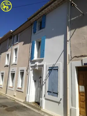 a white building with blue shutters on it at Chez Makita - RdC in Mirepeisset
