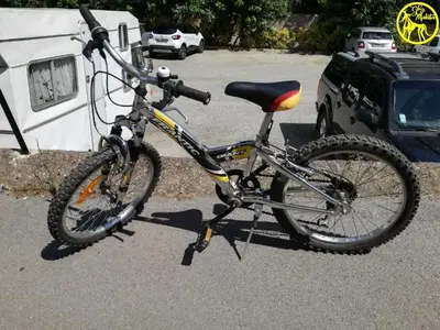 a bike is parked in a parking lot at Chez Makita - RdC in Mirepeisset