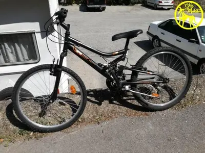 a bike parked on the side of a parking lot at Chez Makita - RdC in Mirepeisset
