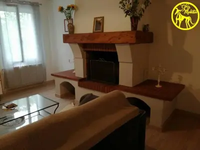 a living room with a fireplace with a tv at Chez Makita - RdC in Mirepeisset