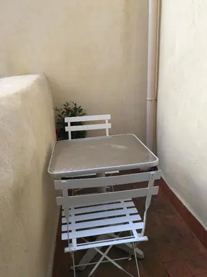a white bed sitting next to a wall at Côté chateau in Carcassonne