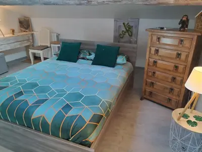 a bedroom with a large bed and a dresser at VILLA ARTEMIA Maison vigneronne - chambre d hôtes-B&B-piscine et spa in Sigean