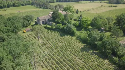 an aerial view of a farm house in a field at Grès Vaillant in Saint-Polycarpe