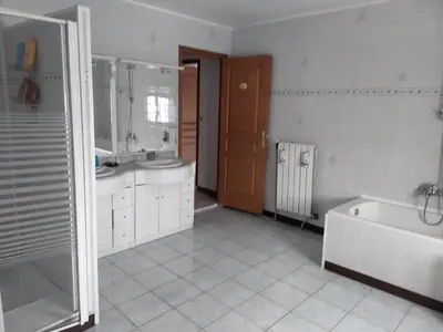 a bathroom with a tub and a sink at Grès Vaillant in Saint-Polycarpe