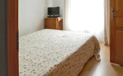 a bedroom with a bed with a white blanket on it at Maison chaleureuse à Nages avec vue sur lac et montagne in Nages