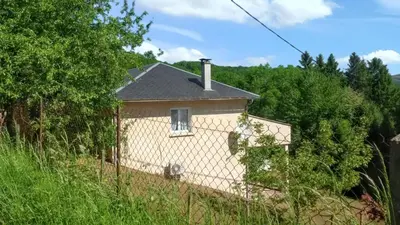 a small house in the middle of a field at Maison chaleureuse à Nages avec vue sur lac et montagne in Nages