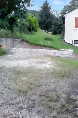 an empty driveway with a yard and a house at Maison chaleureuse à Nages avec vue sur lac et montagne in Nages