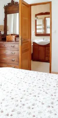 a bathroom with a bed and a sink and a mirror at Maison chaleureuse à Nages avec vue sur lac et montagne in Nages