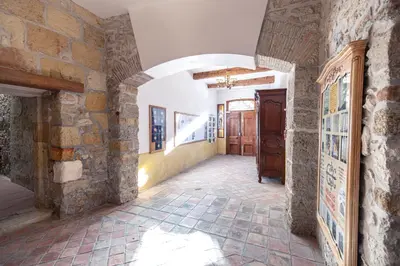 a hallway of a house with a stone wall at Studio du couvent in Narbonne
