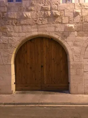 a wooden garage door in a stone building at Studio du couvent in Narbonne