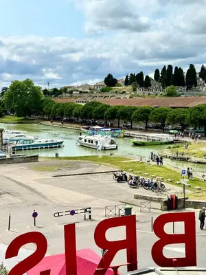 a living room with a table and a kitchen at le bristol appartement Canal & Chénier CanalduMidi in Carcassonne