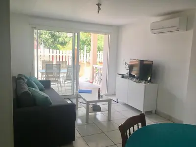 a living room with a couch and a television at La Belle Gruissanaise in Gruissan