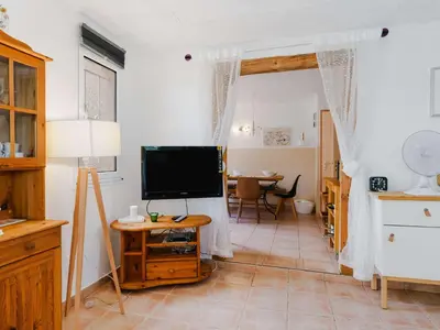 a living room with a television and a table at CE12 Pavillon 3 pièces 6 couchages proche plage du Grazel - FR-1-409-70 in Gruissan