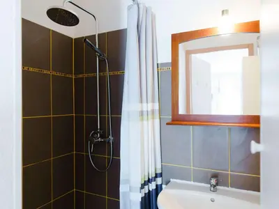 a bathroom with a shower and a sink and a mirror at CE12 Pavillon 3 pièces 6 couchages proche plage du Grazel - FR-1-409-70 in Gruissan