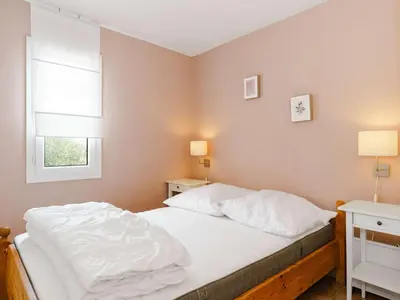 a bedroom with a bed with white sheets and two windows at CE12 Pavillon 3 pièces 6 couchages proche plage du Grazel - FR-1-409-70 in Gruissan