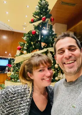 a man and a woman standing in front of a christmas tree at Casa Cessenon in Cessenon