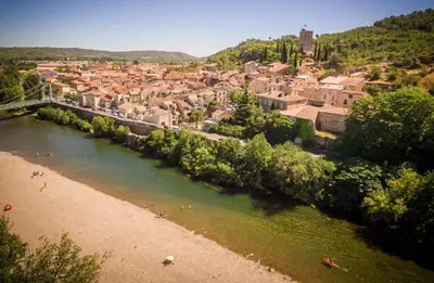 a view of a town with a river and a city at Casa Cessenon in Cessenon