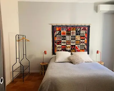 a bedroom with a bed with a colorful head board at Casa Cessenon in Cessenon