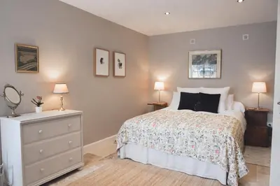 a bedroom with a bed and two lamps and a dresser at Maison Marie in Lagarde