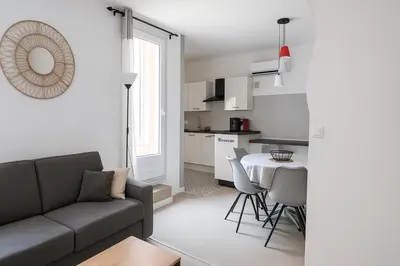 a living room with a couch and a table at Appartement avec Terrasse in Narbonne