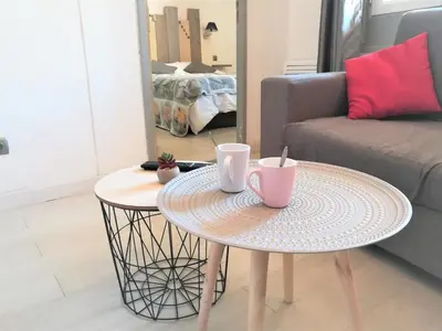 a table with two cups on it in a living room at Appartement avec Terrasse in Narbonne