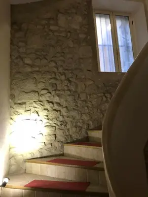 a set of stairs in a stone building with a window at Chambre du couvent in Narbonne