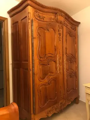 a large wooden cabinet in the corner of a room at Chambre du couvent in Narbonne