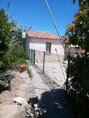 a fence in front of a small house at Maison du Charron in Azillanet