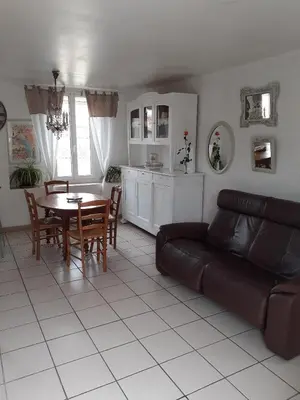 a living room with a couch and a table at Maison du Charron in Azillanet