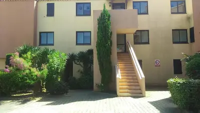 a building with a staircase in front of a building at EN BORD DE MER in Gruissan