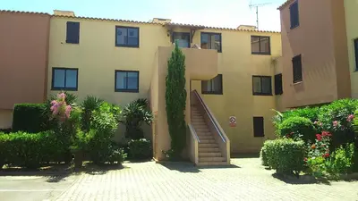 a building with a staircase in front of it at EN BORD DE MER in Gruissan