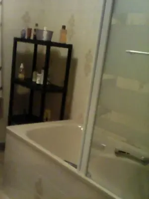 a bathroom with a shower and a bath tub with a glass door at La maison des vendangeurs in Trausse