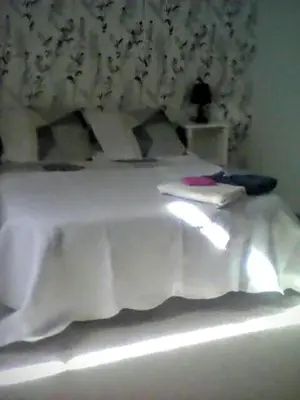 a bedroom with a white bed with white sheets at La maison des vendangeurs in Trausse