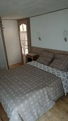 a bedroom with two beds and a window at La carole in Mosset