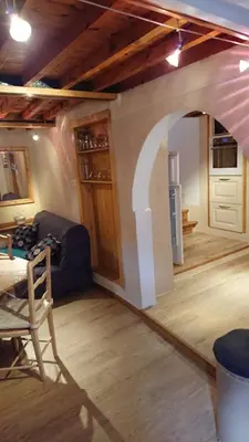 an archway in a living room with a couch and a table at La carole in Mosset