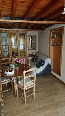 a bedroom with a bed and a table and chairs at La carole in Mosset