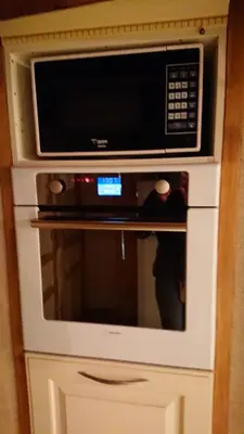 a microwave oven sitting on top of a cabinet at La carole in Mosset