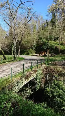 a wooden fence next to a path in a park at La carole in Mosset