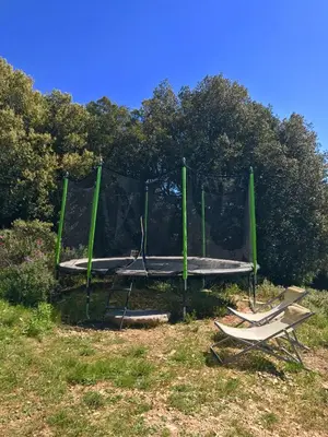 a trampoline with a net in a field at Glamping Tent Joy in Vélieux