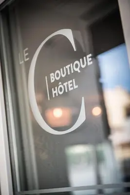 a close up of a sign on a glass door at Hôtel Le C - Boutique Hôtel in Narbonne