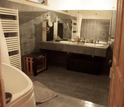 a bathroom with two sinks and a large mirror at la chambre claire in Sigean