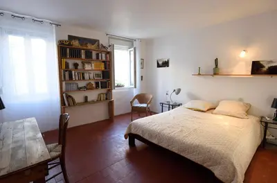 a bedroom with a bed and a book shelf at la chambre claire in Sigean