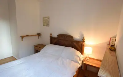 a bedroom with a white bed and a lamp at la chambre claire in Sigean