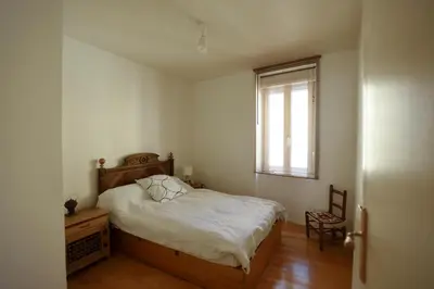 a small bedroom with a bed and a window at la chambre claire in Sigean