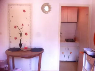 a room with a table and a kitchen with a table sidx sidx sidx at Studio confortable, Rennes les bains, 17 m² + Balcon in Rennes-les-Bains