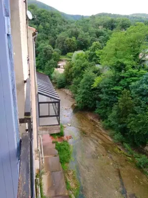 a balcony of a building with a view of a river at Studio confortable, Rennes les bains, 17 m² + Balcon in Rennes-les-Bains