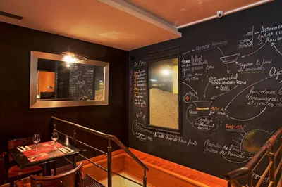 a restaurant with a chalkboard wall with writing on it at Maison du Cassoulet in Castelnaudary