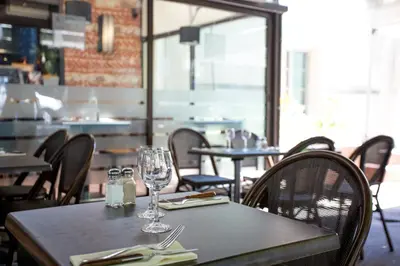 a table with wine glasses on it in a restaurant at Maison du Cassoulet in Castelnaudary