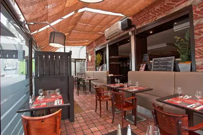 a dining room with tables and chairs in a restaurant at Maison du Cassoulet in Castelnaudary